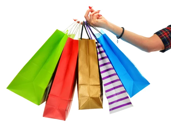 Female hand holding paper shopping bags isolated on white — Stock Photo, Image