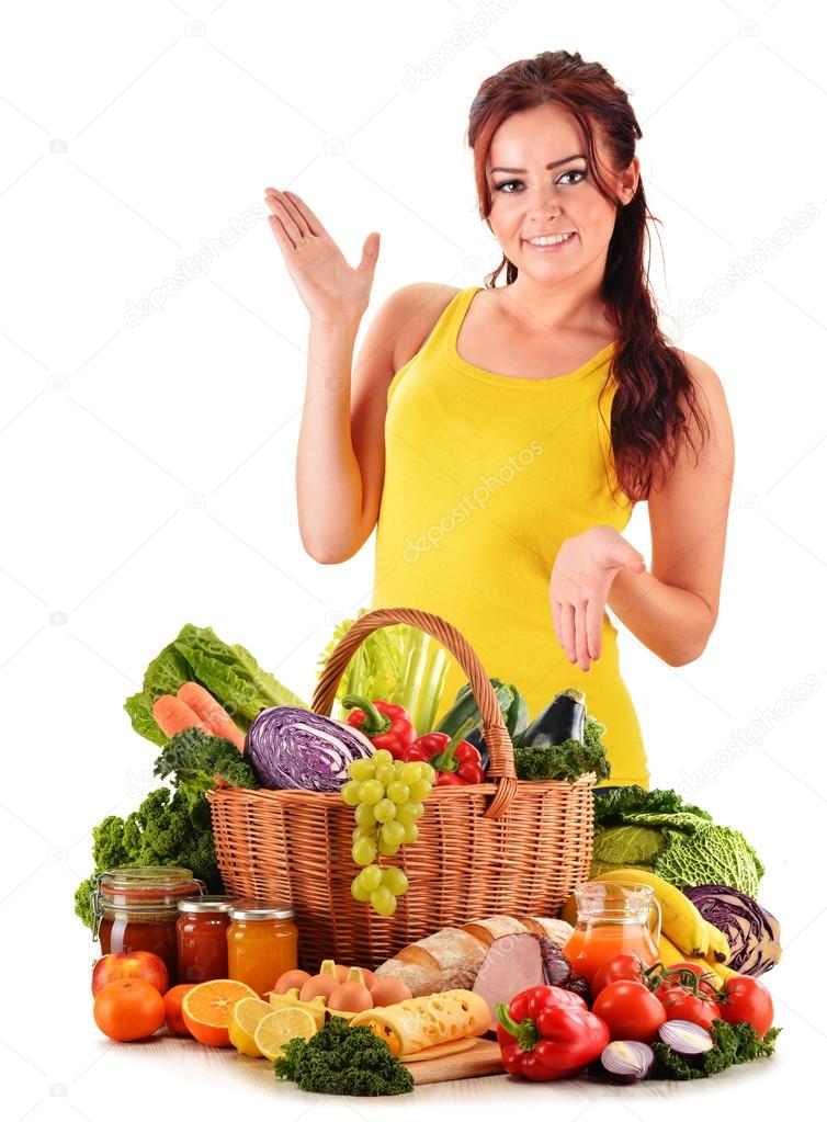 Young woman with assorted grocery products isolated on white