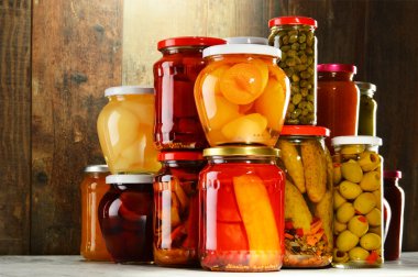 Jars with pickled vegetables, fruity compotes and jams isolated  clipart