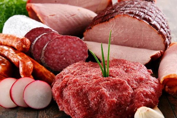 Асорті м'ясних продуктів, включаючи шинку та сосиски — стокове фото