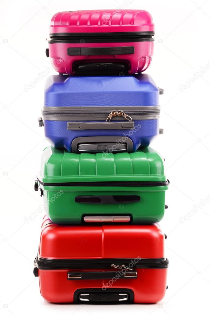 Stack of plastic suitcases isolated on white