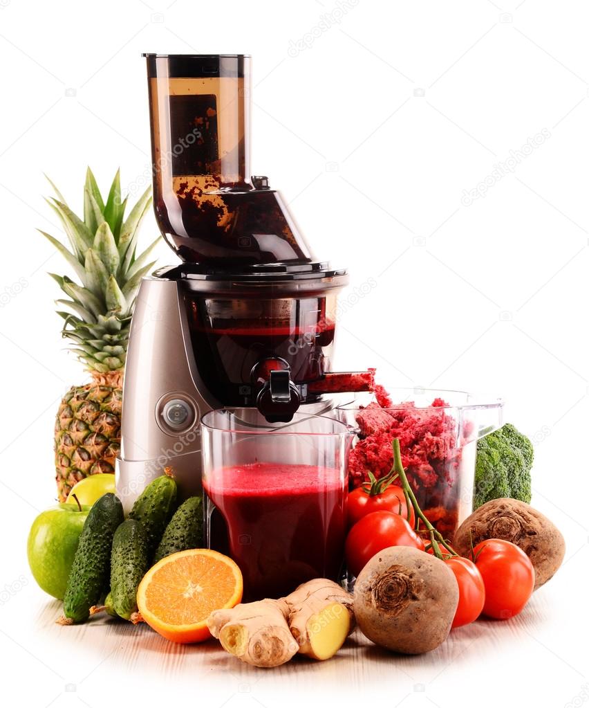 Slow juicer with organic fruits and vegetables isolated on white