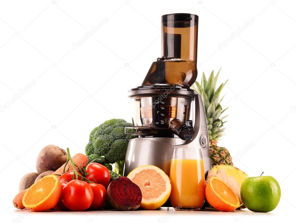 Slow juicer with organic fruits and vegetables isolated on white