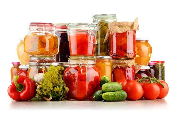 Jars with pickled vegetables and fruity compotes on white — Stock Photo, Image