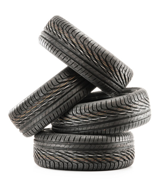 Four new black tires isolated on white