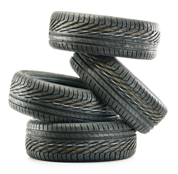 Four new black tires isolated on white