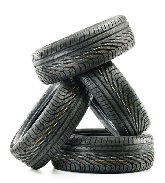 Four new black tires isolated on white