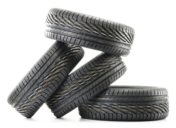 Four new black tires isolated on white