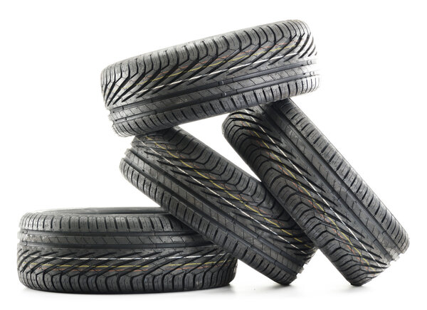 Four new black tires isolated on white
