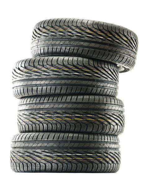 Four new black tires isolated on white