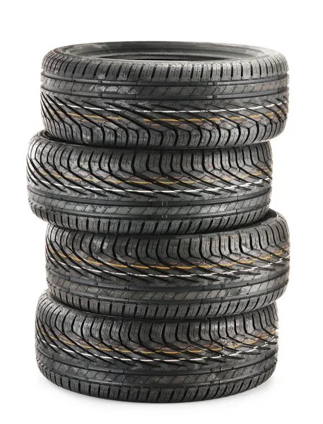 Vier neue schwarze Reifen isoliert auf weiß — Stockfoto