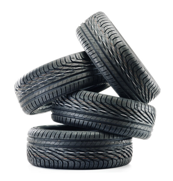 Four new black tires isolated on white