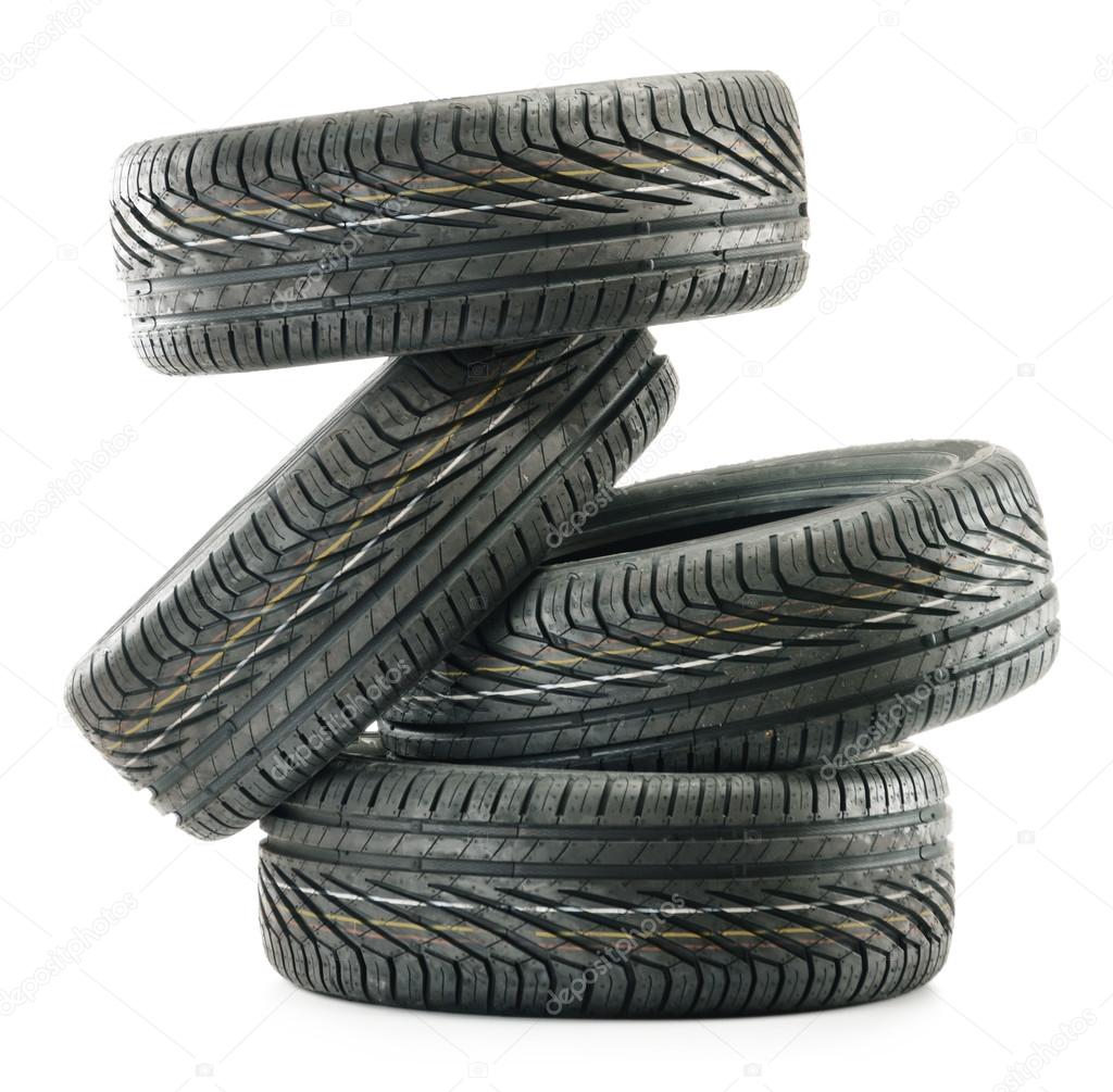 Four new black tires isolated on white