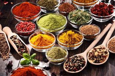 Mutfak masasında çeşitli baharat ve bitkiler var..