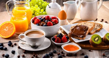 Kahve, portakal suyu, kruvasan, tahıl ve meyve ile kahvaltı. Dengeli beslenme.