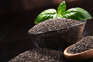 Chia tohum ahşap masa üzerinde kase ile kompozisyon.