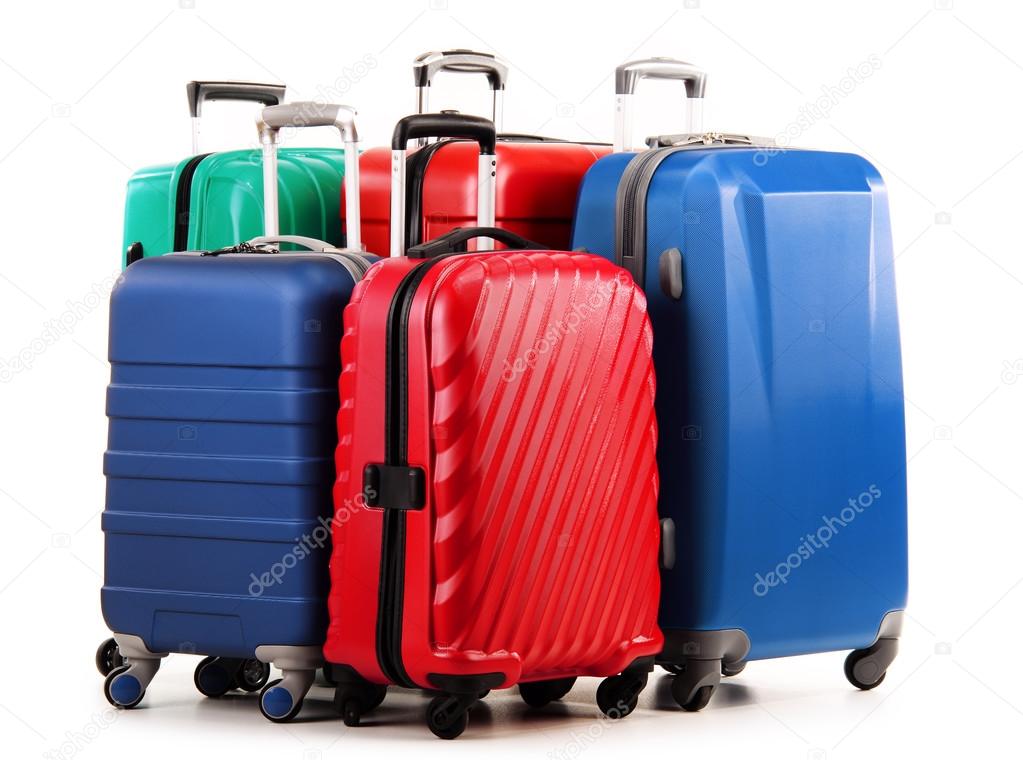 Five plastic suitcases isolated on white