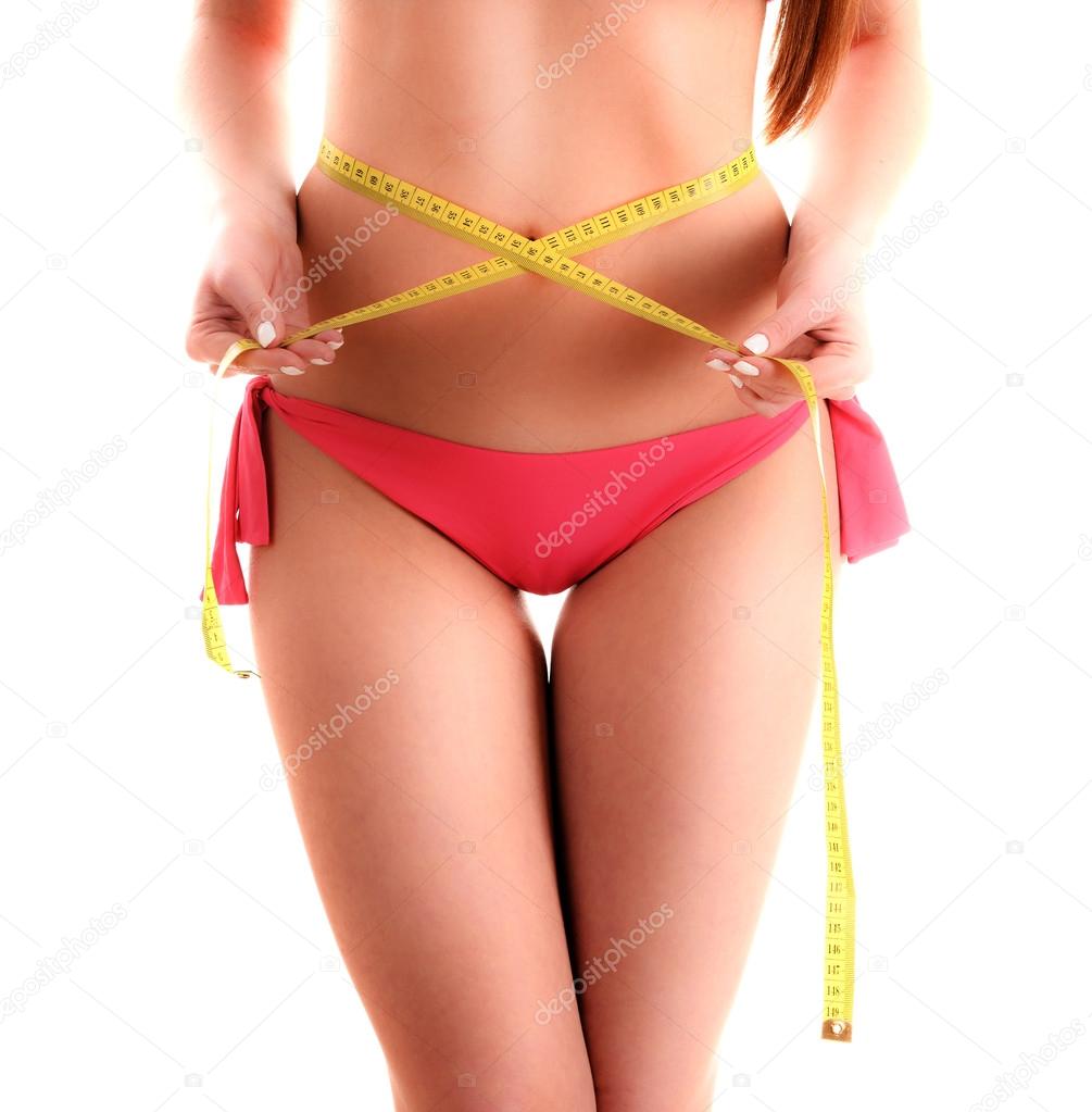 Body of sexy young woman measuring herself. Weight loss.
