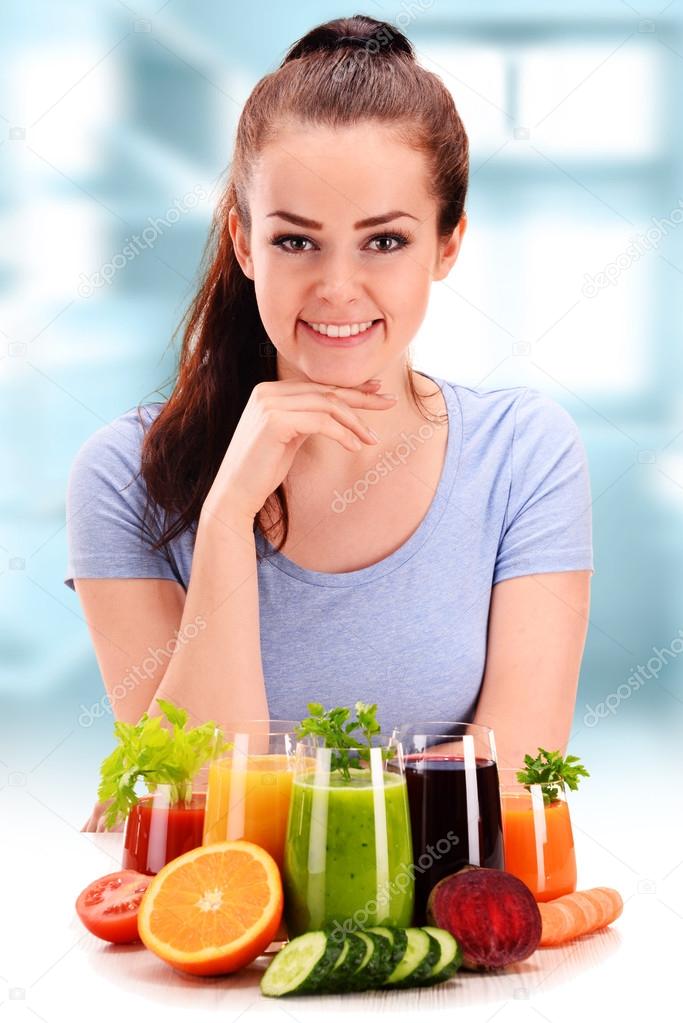 Young woman with variety of vegetable and fruit juices