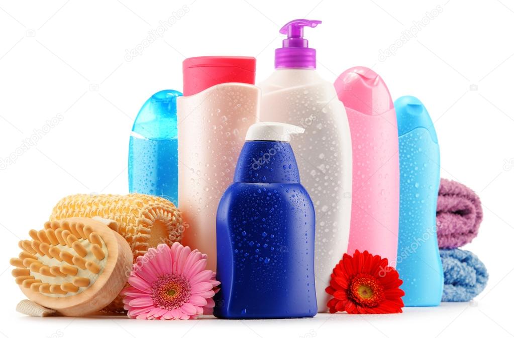 Plastic bottles of body care and beauty products over white