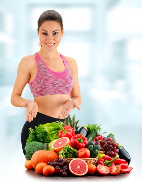 Mujer joven con variedad de verduras y frutas orgánicas — Foto de Stock