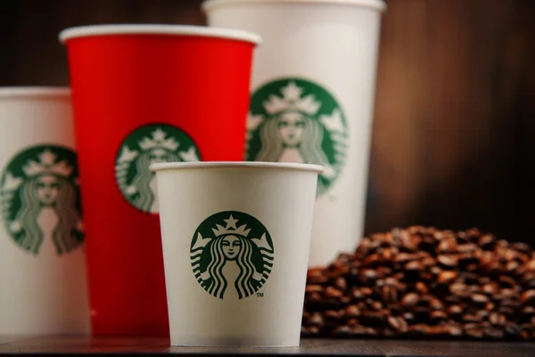 Composition with cup of Starbucks coffee and beans — Stock Photo, Image