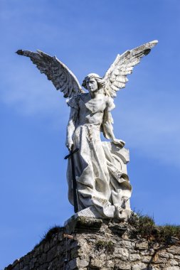 Sculpture of a Guardian angel with a sword in the cemetery of Comillas