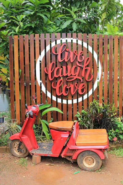 Live Laugh Love and red scooter at Kantang Railway Station — Stock Photo, Image