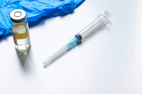 the syringe and the vaccine are on the table. the concept of global vaccination against covid-19