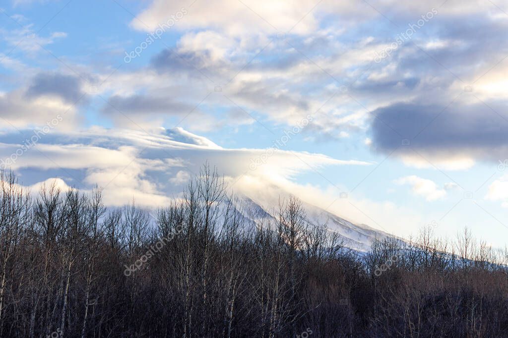 The Koryaksky volcano is covered with clouds at sunrise. still considered as acting volcano. August 20 is the day of the volcano in Kamchatka