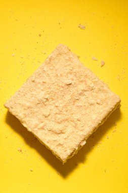 Napoleon cake on a yellow background. Filmed from above. Place for a logo.