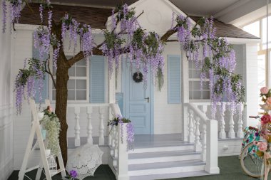 House facade with blue door, porch, staircase and courtyard