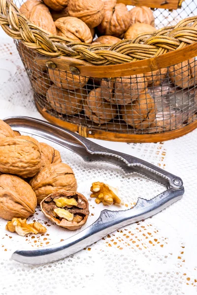 Cracked walnuts and a nutcraker — Stock Photo, Image