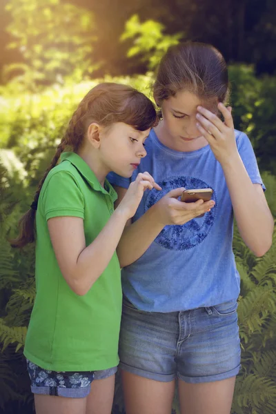 Little girls playing with phone — Stock Photo, Image