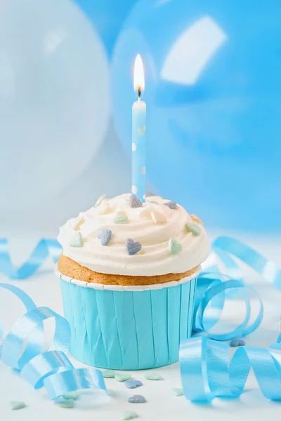 Blue cup cake with birthday candle — Stock Photo, Image