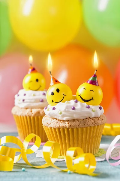 Cupcakes with smiley candles — Stock Photo, Image