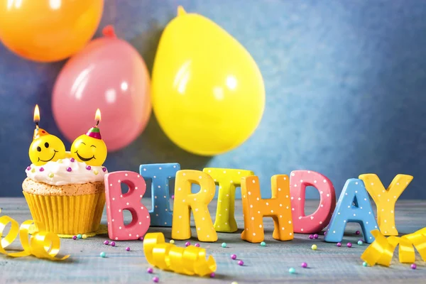 Cupcakes with smiley candles — Stock Photo, Image