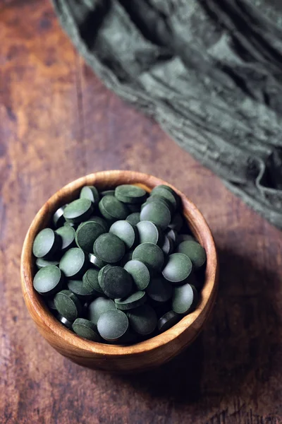 Spirulina tablets in a bowl — Stock Photo, Image