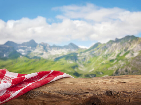 Empty wooden table with red napkin