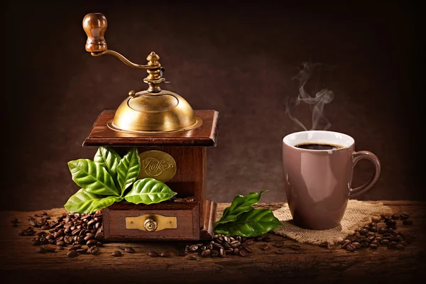 Coffee mill and a cup of coffee Royalty Free Stock Images