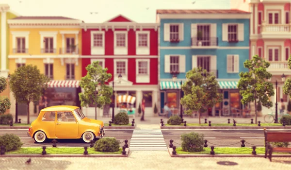 Cute little car goes by the road — Stock Photo, Image