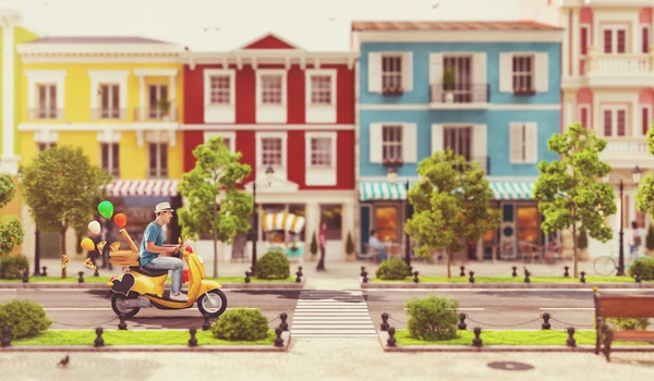 Cheerful man on the cute funny scooter — Stock Photo, Image
