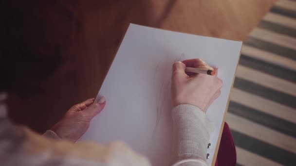 Vrouw kunstenaar schetsen op Witboek. — Stockvideo