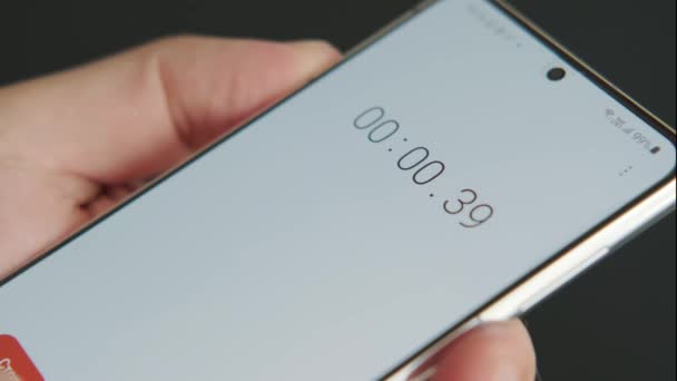 Close up of smartphone with digital stopwatch or timer on the screen. — Stock Video