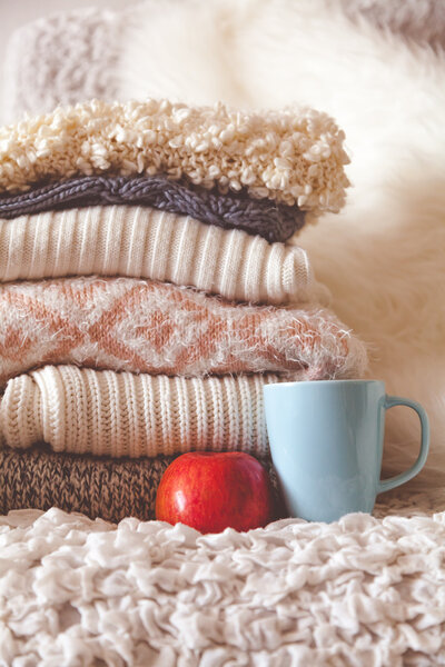 Stack of cozy knitted sweaters