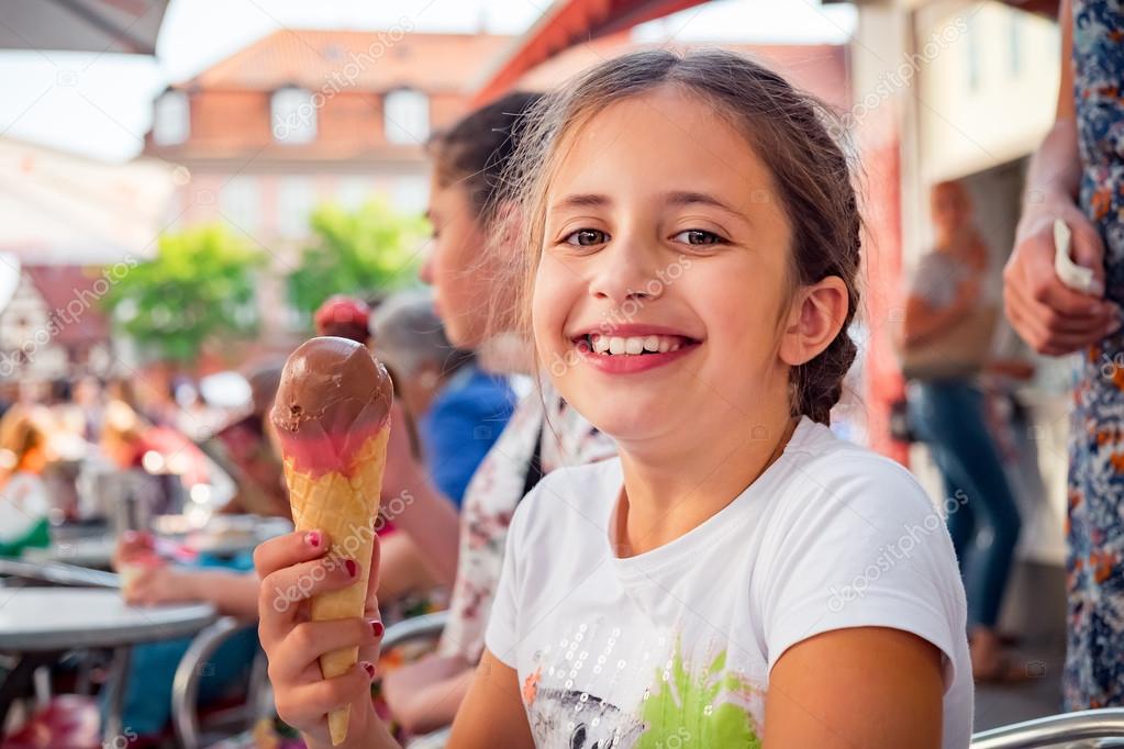 Young girl eats ice cream