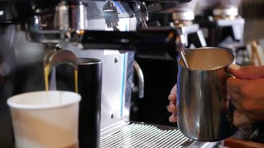 Demir bir sürahide kapuçino için köpüklü süt.