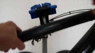 Adam servis standına motosiklet kuruyor.