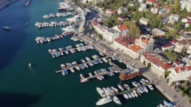 Yatı olan şehir iskelesi, güneşli yaz günlerinde hava manzarası. Kırım, kar maskesi
