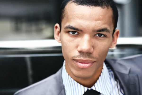 Close up portrait of a happy black man in his 20s in modern office — Stock Photo, Image